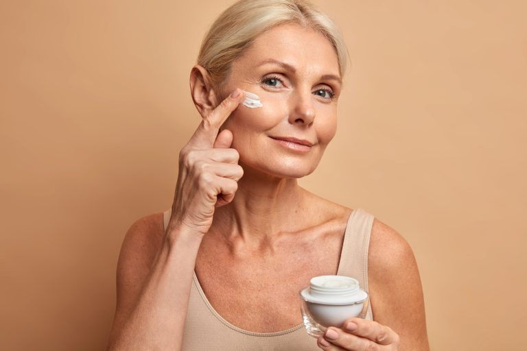middle aged beautiful woman applies anti aging cream face undergoes beauty treatments cares about skin scaled 1